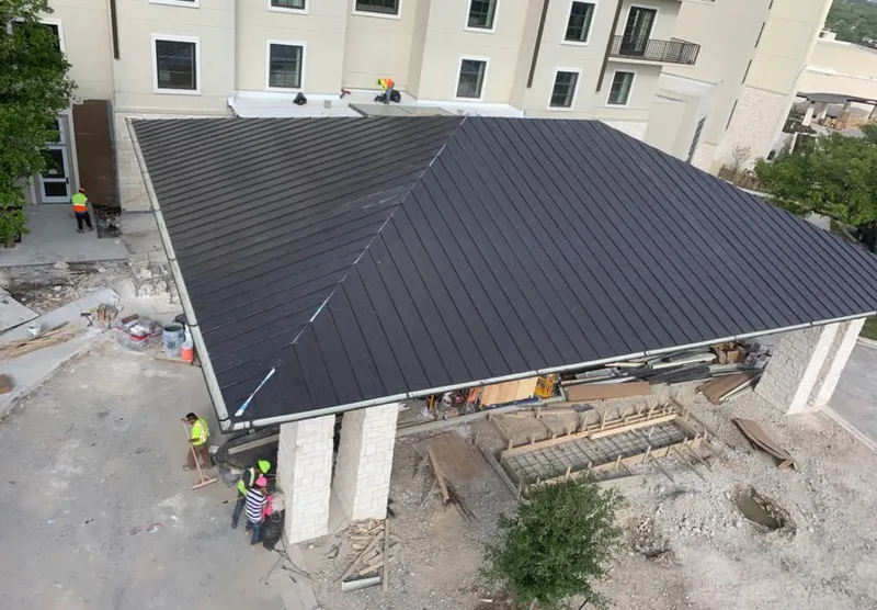 Metal roofing installation team working on a commercial building in Willow Oak